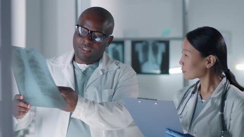 Doctors Reviewing Chest X-Ray in Hospital Setting