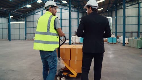 Factory Workers Deliver Boxes Package on a Pushing Trolley in the Warehouse
