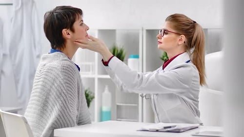 Healthcare Worker Examines Patient in Bright Medical Office