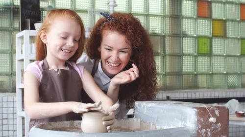 Kid and Teacher Are in Workshop, Kid's Hands Are Sculpting a Figurine