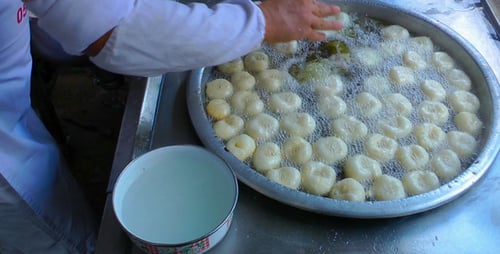 Frying Dough for Sweet Treat on Countertop