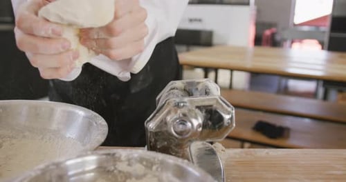 Chef Preparing Dough in Brightly Lit Kitchen