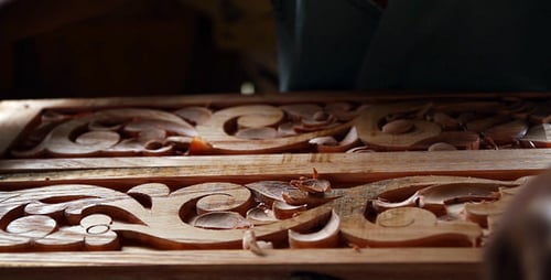 Artisan Hand Carving Floral Details in Wooden Panel