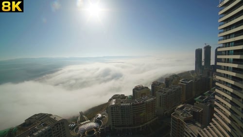 Dramatic Cityscape Above the Clouds on Sunny Day