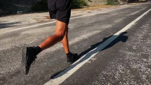 Person Running on Asphalt Road in Daytime