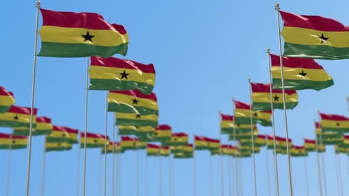 Ghana Flags Waving Seamlessly Against Clear Blue Sky