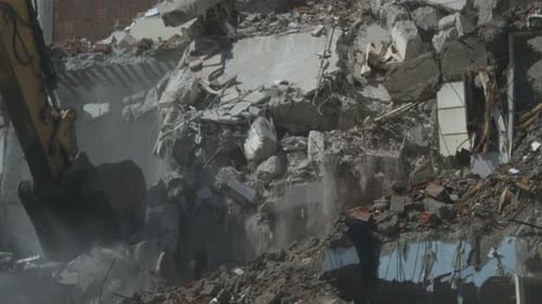 Excavator Demolishing Building in Urban Setting