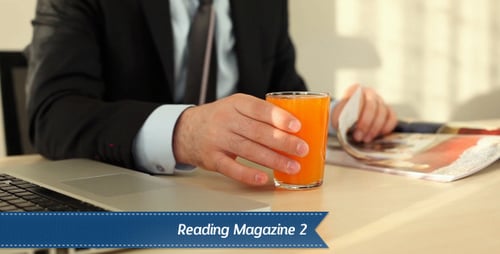 Professional Man Drinks Juice Reading a Magazine