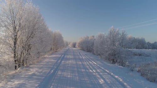 Snowy Road Through Frozen Winter Landscape