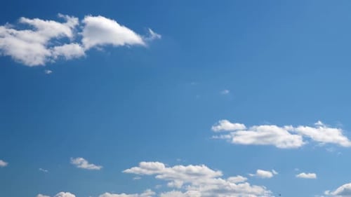White Clouds Drifting Across a Deep Blue Sky