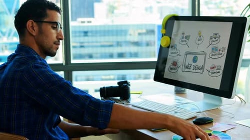 Man Working on Web Design in Office