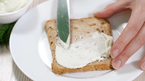 Spreading Creamy Spread onto Whole Grain Bread