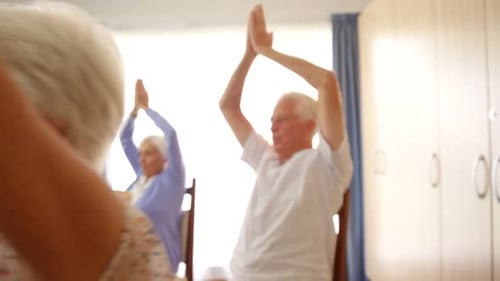 Senior Adults Exercising Arms in Group Fitness Class