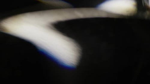 Abstract Flowing Light Effects Against Black Background