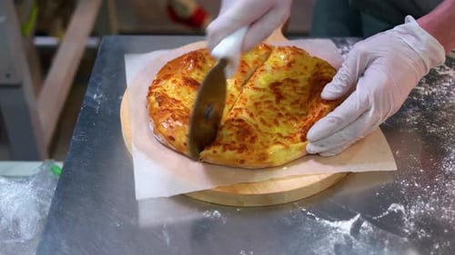 Cutting Fresh Baked Golden Pizza Close Up