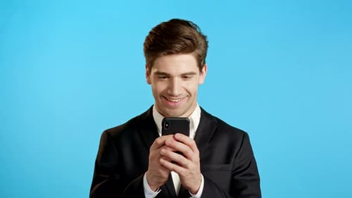 Man Reacting While Using a Smartphone