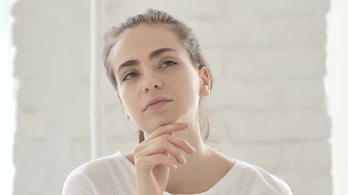 Portrait of Thinking Middle Aged Young Woman in Office