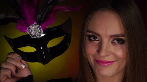 Woman Smiles with Masquerade Mask in Close Up