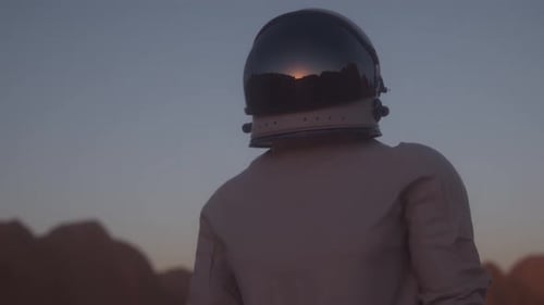 Portrait Shot of the Astronaut Wearing in Helmet on the Distant Planet