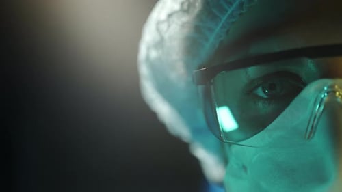 Portrait of a Female Doctor in Medical Uniform is Looking at Camera at Hospital Close Up