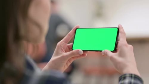 Female Watching Smartphone with Green Chroma Key Screen