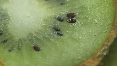 Slices Of Kiwi Fruit In Fizzing Soda
