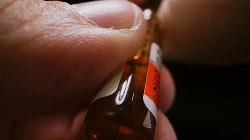 Close Up Opening Small Ampule of Liquid Medicine