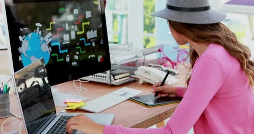 Woman Working on Tablet at Creative Office Desk