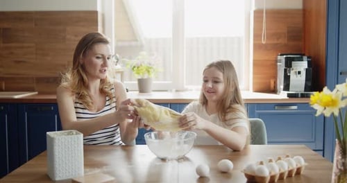 Mother and Child Baking Together in Sunny Kitchen
