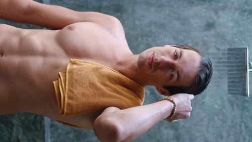 Fit Man Smiling in Shower After Workout