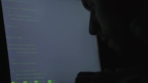Silhouette of Hacker Coding at Night