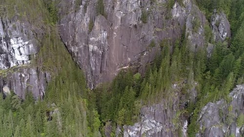 Aerial Of Granite Rock Face On Large Mountain Cliffs In North American Forest
