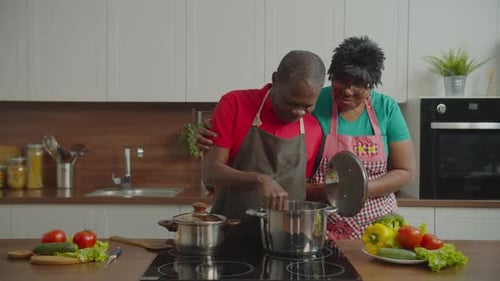 Adult Couple Cooking Together in Home Kitchen