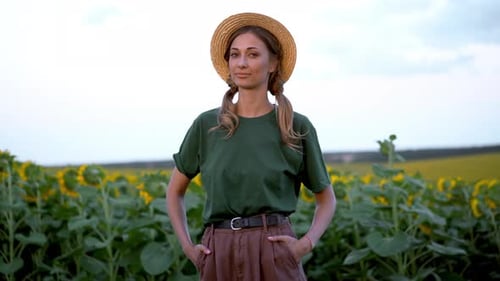 Woman agronomist standing agricultural sunflower field
