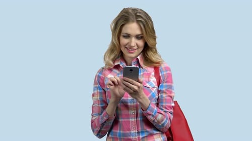 Woman Smiling Using Smartphone