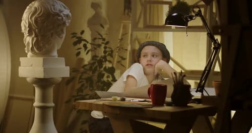 Young Artist Drawing at Table