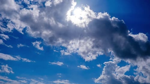 Timelapse of Cumulus Clouds Moving Under the Sun in the Blue Sky Cloud Space