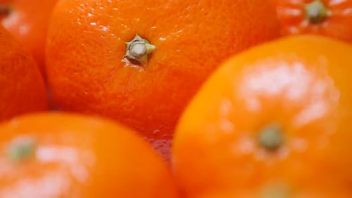 Orange fresh tangerines on plate healthy fruit orange background 1080p FullHD video - Slow tilt on f