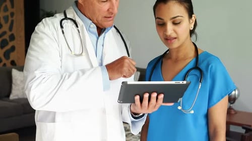 Medical Staff Examining Tablet in Modern Office Setting