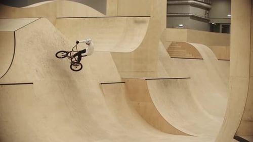 BMX Sports Young Man Riding on the Ramps