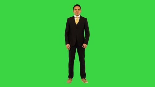 Smiling Man Gesturing Against Green Screen