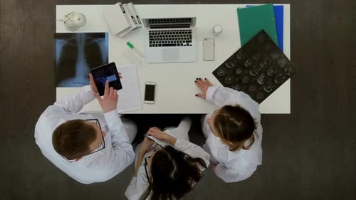 Medical Team Reviewing X-Rays in Hospital Overhead Shot