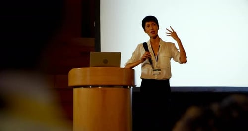 Young Asian businesswoman speaking in business seminar in auditorium 4k