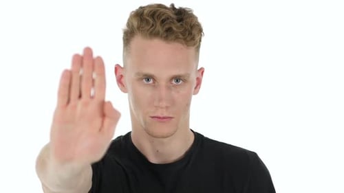 Young Adult Makes Stop Gesture on White Background
