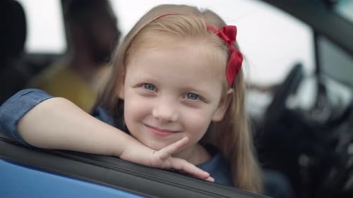 Charming Child Smiles in Car During Road Trip