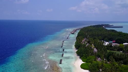 Aerial drone panorama of tropical shore beach break by clear water with sand background