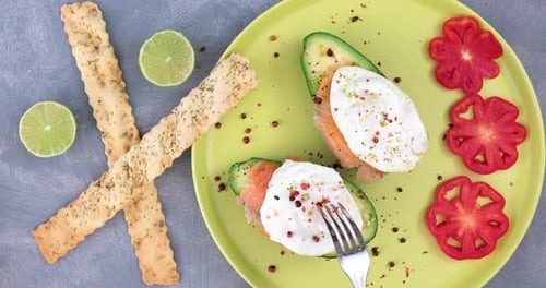 Avocado Toast with Egg Being Cut on Plate
