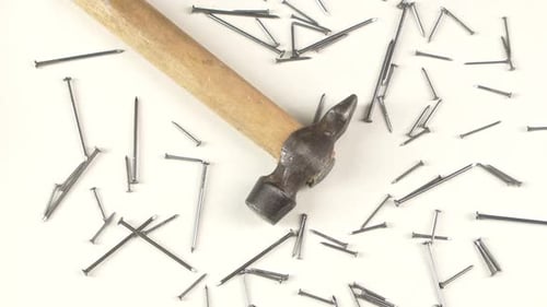 Close Up of Hammer with Nails on White Background