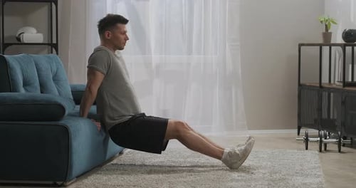 Man Doing Tricep Dips on Couch for Workout