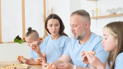 Family Enjoying Pizza Together at Home